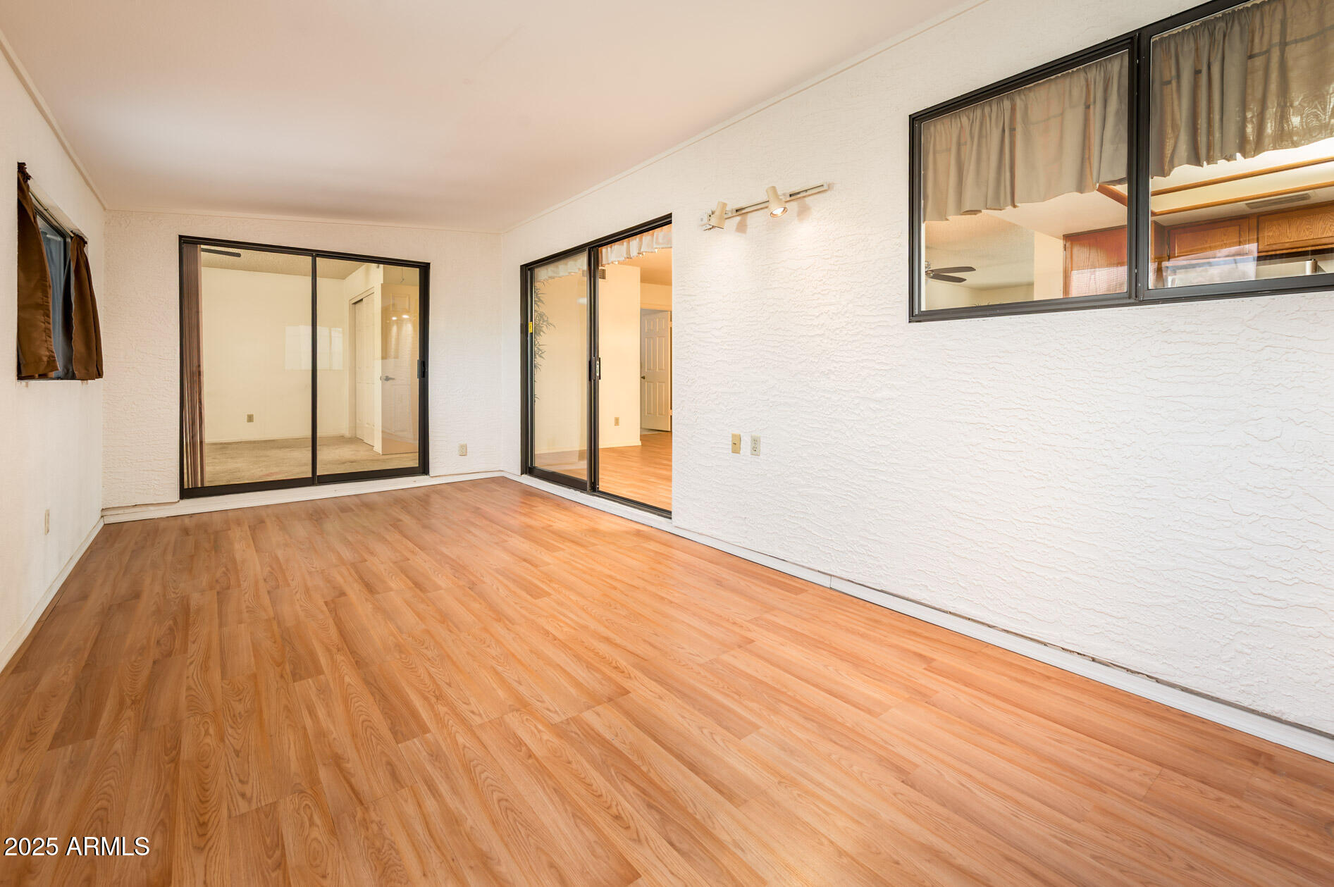 538 South 76th Place Mesa, AZ 85208 - Photo 12 of 50 a view of an empty room with window and wooden floor