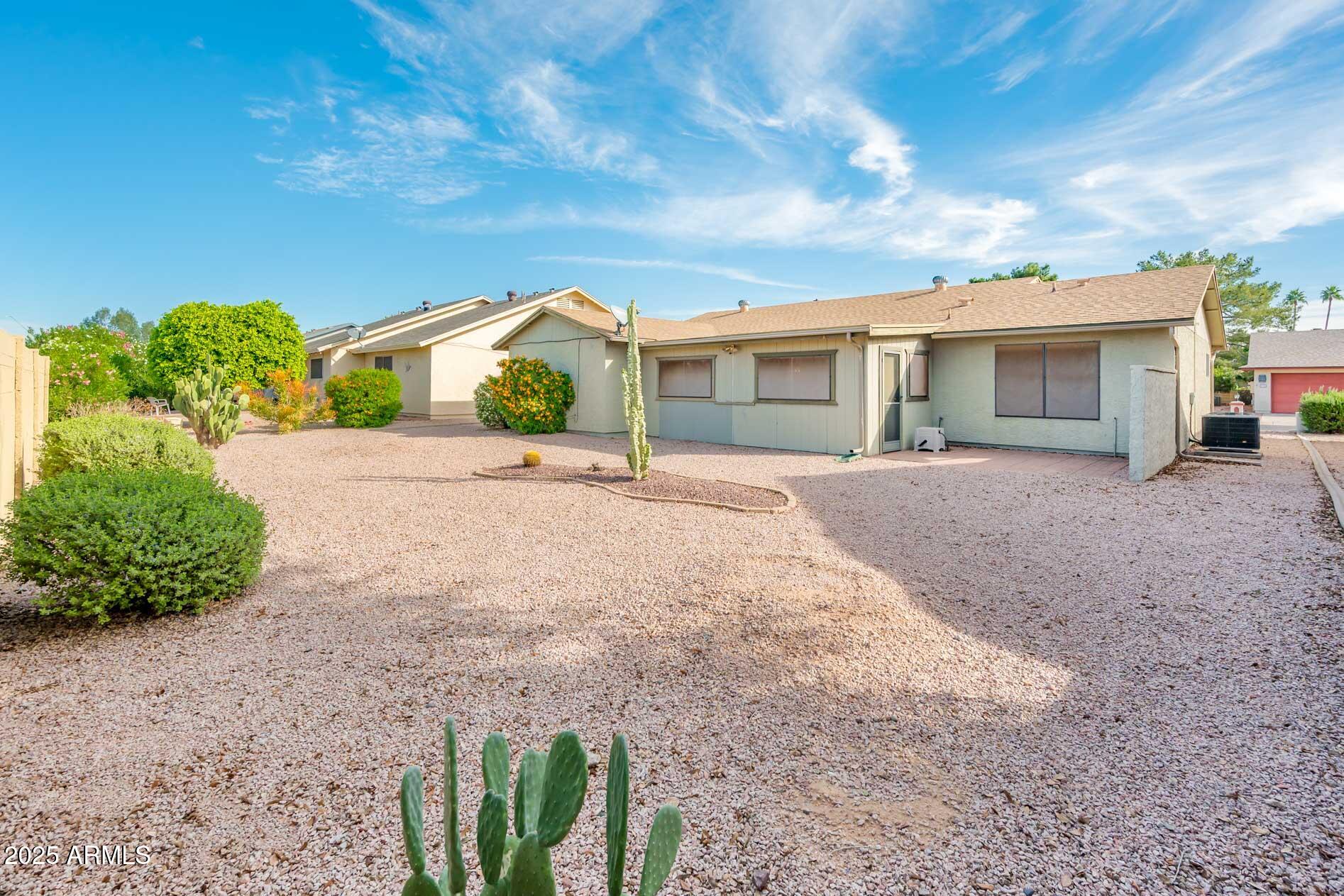 538 South 76th Place Mesa, AZ 85208 - Photo 23 of 50 a front view of a house with a yard and potted plants
