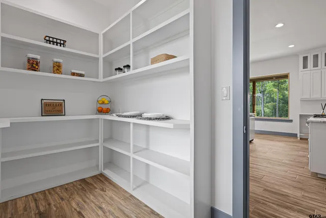 a bathroom with a granite countertop sink and a large mirror