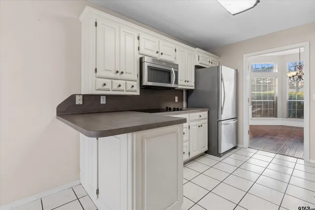 a kitchen with stainless steel appliances a sink a stove a microwave and cabinets