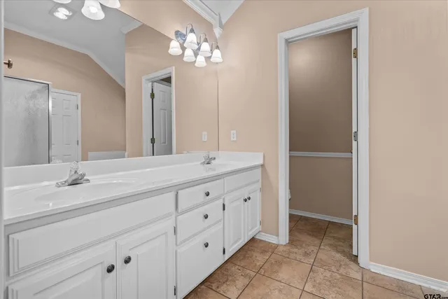 a spacious bathroom with double sink and a mirror