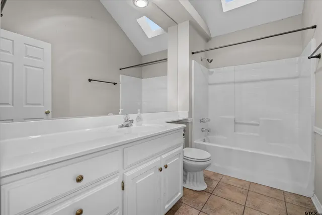 a bathroom with a double vanity sink toilet mirror and shower