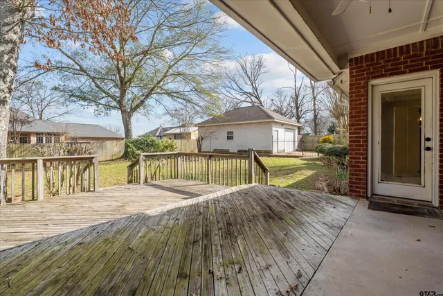 a view of backyard with a garden and trees
