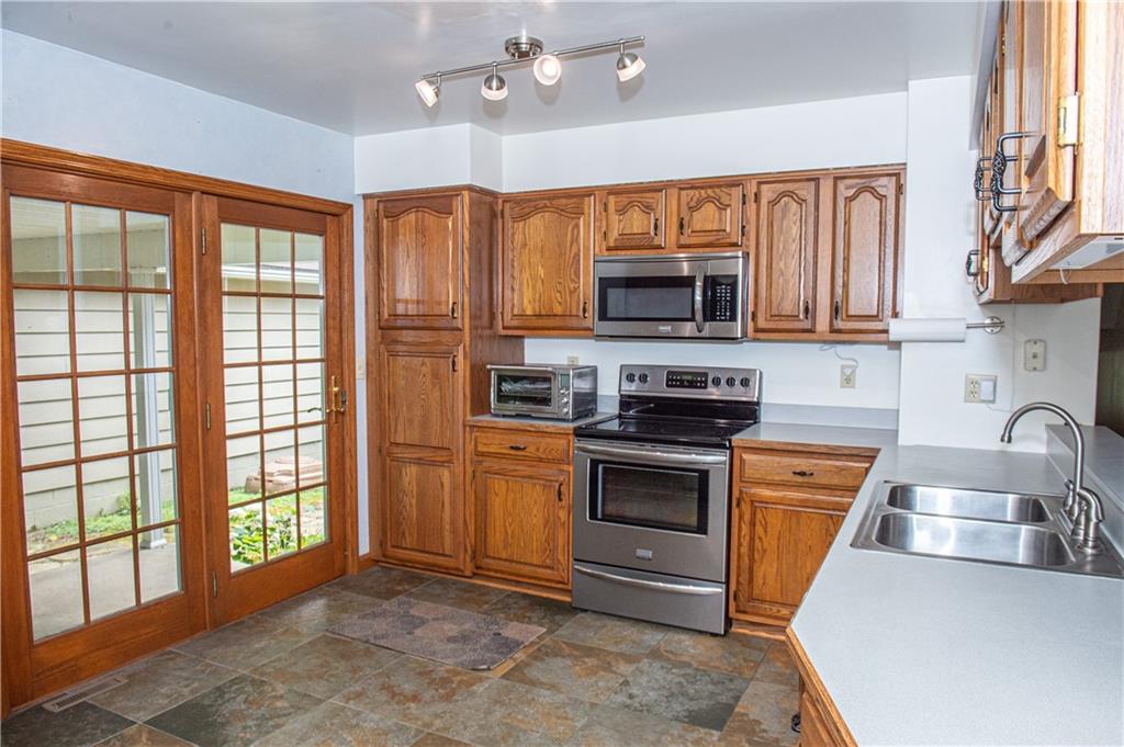 1294 Union Valley Road New Castle, PA 16101 - Photo 8 of 36 a kitchen with stainless steel appliances granite countertop a stove sink and microwave
