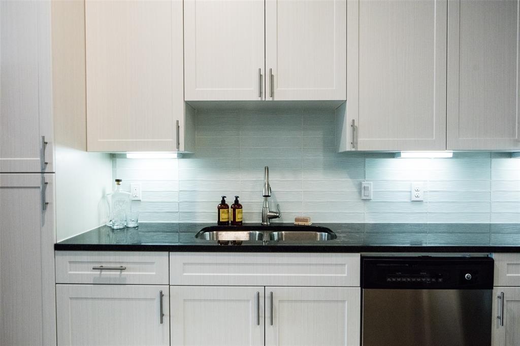 7606 Eastern Avenue, Unit 301 Dallas, TX 75209 - Photo 3 of 5 a kitchen with white cabinets and a sink