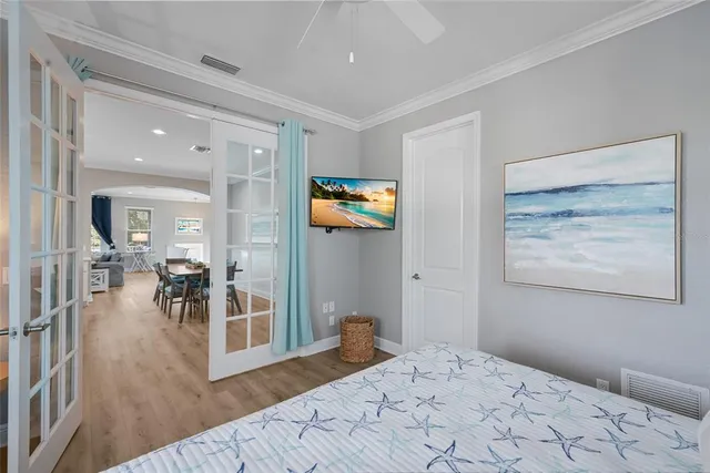 a spacious bedroom with a bed and a wooden floor