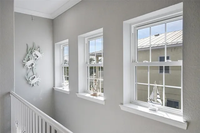 a spacious bedroom with a bed and a chandelier