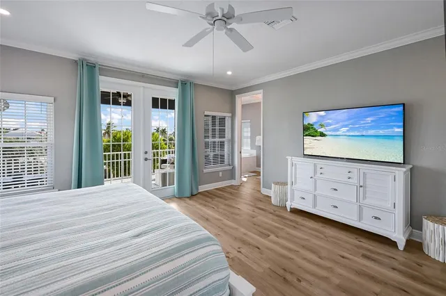 a bedroom with a large bed and a chandelier