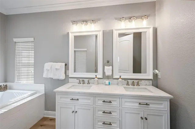 a vase of flowers sitting on a table in front of a window