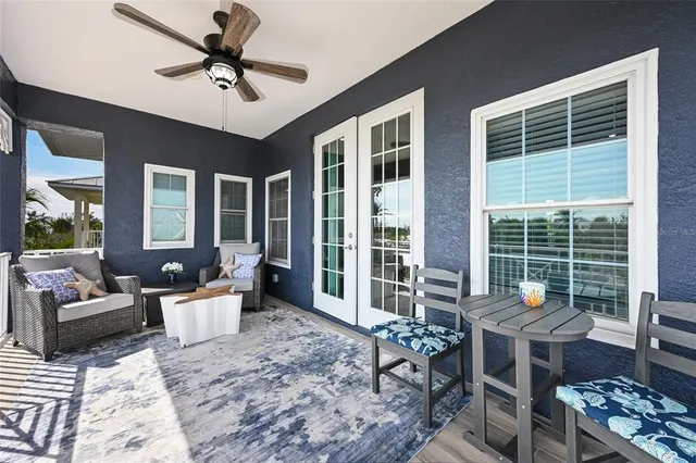 a living room with furniture and ceiling fan