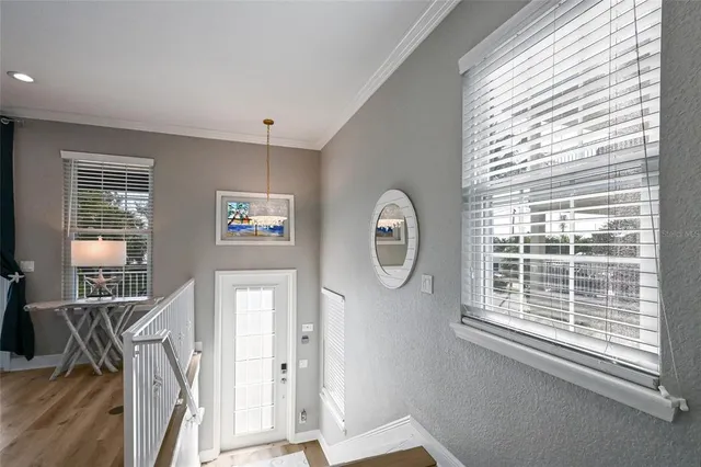 a view of a livingroom with wooden floor and a large window