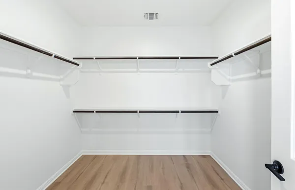 a spacious bathroom with a tub sink shower and mirror