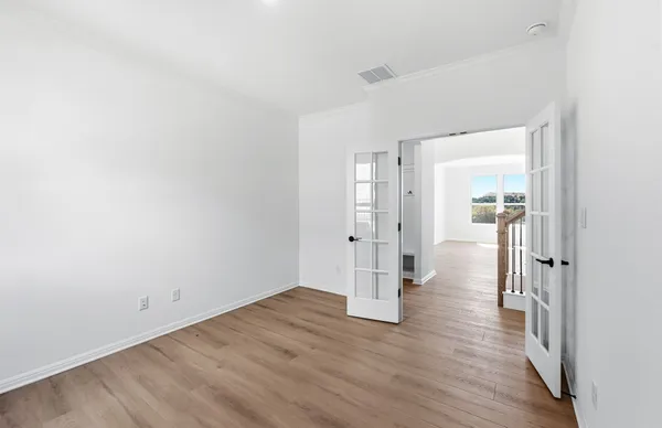 a view of a hallway with a window and a ceiling fan