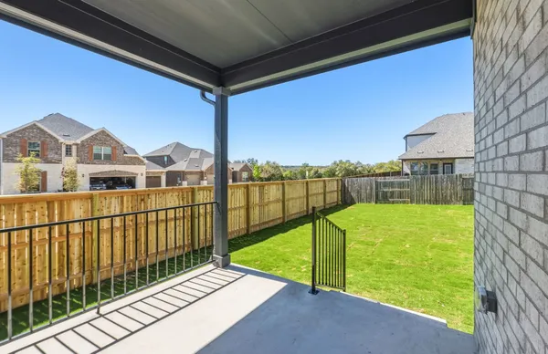 a front view of a house with a yard table and chairs