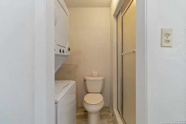 a white toilet sitting next to a bathroom sink