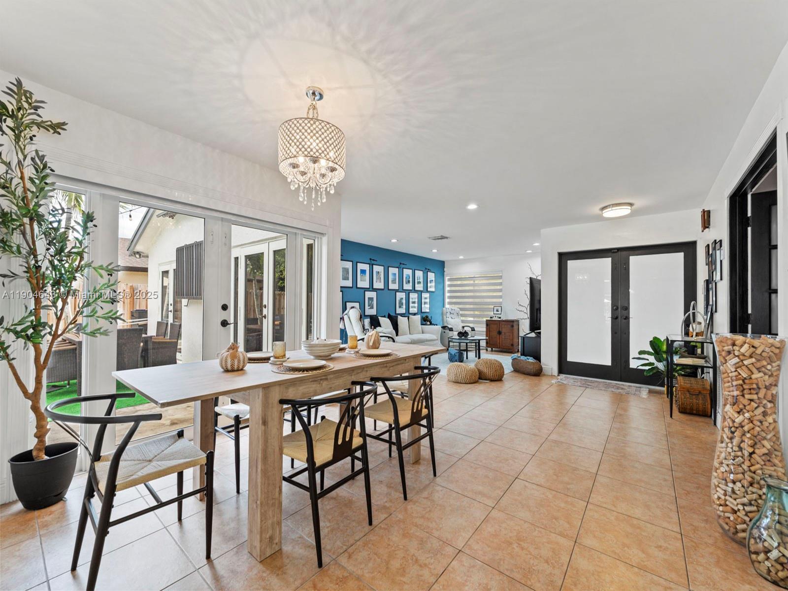12825 Southwest 107th Terrace Miami, FL 33186 - Photo 13 of 43 a view of a dining room with furniture and chandelier
