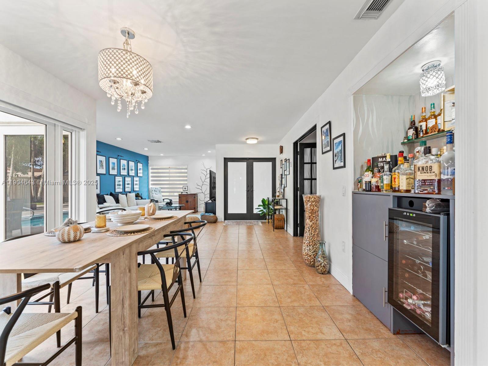 12825 Southwest 107th Terrace Miami, FL 33186 - Photo 14 of 43 a view of a dining room with furniture and chandelier