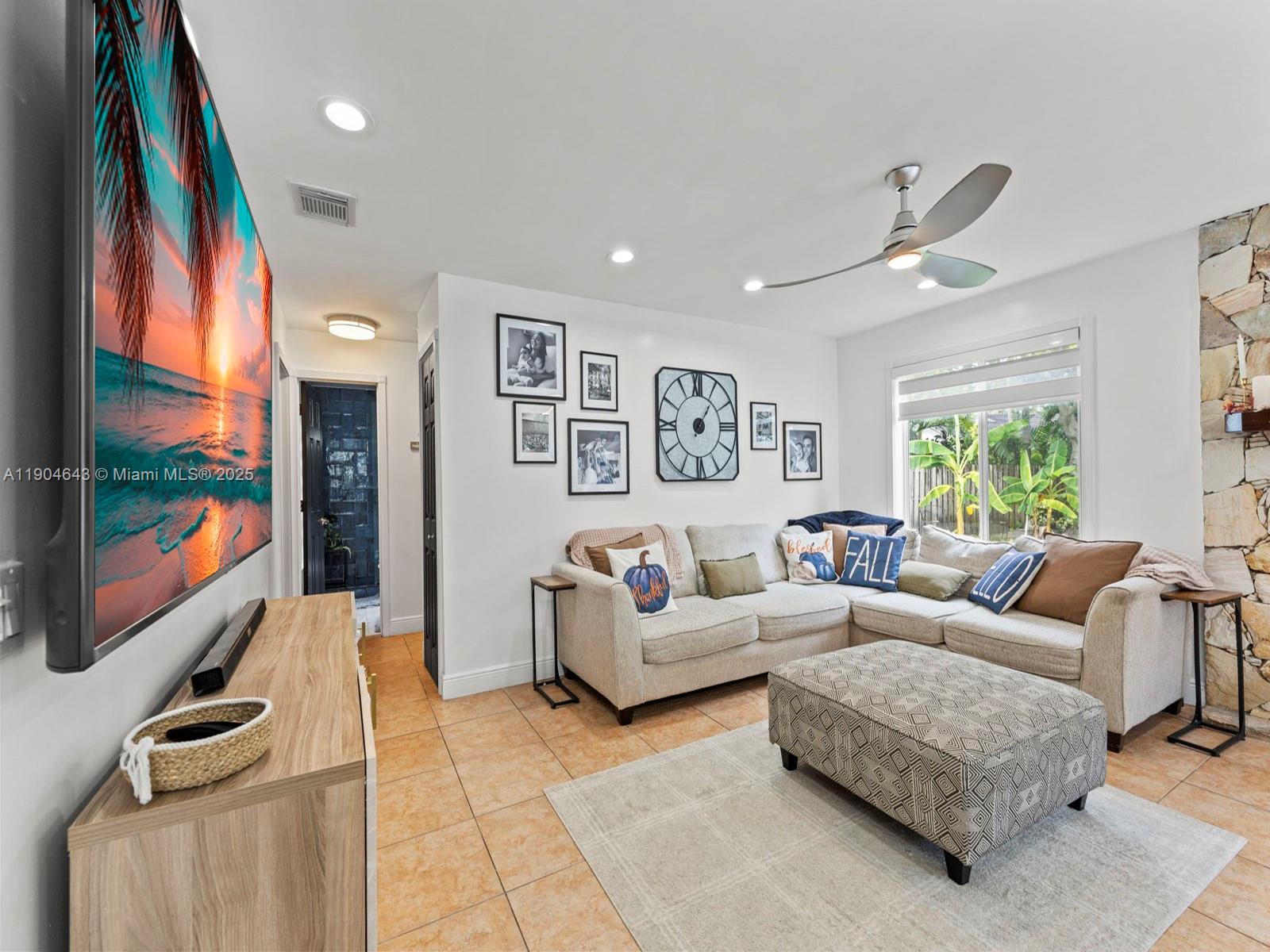12825 Southwest 107th Terrace Miami, FL 33186 - Photo 21 of 43 a living room with furniture and a flat screen tv