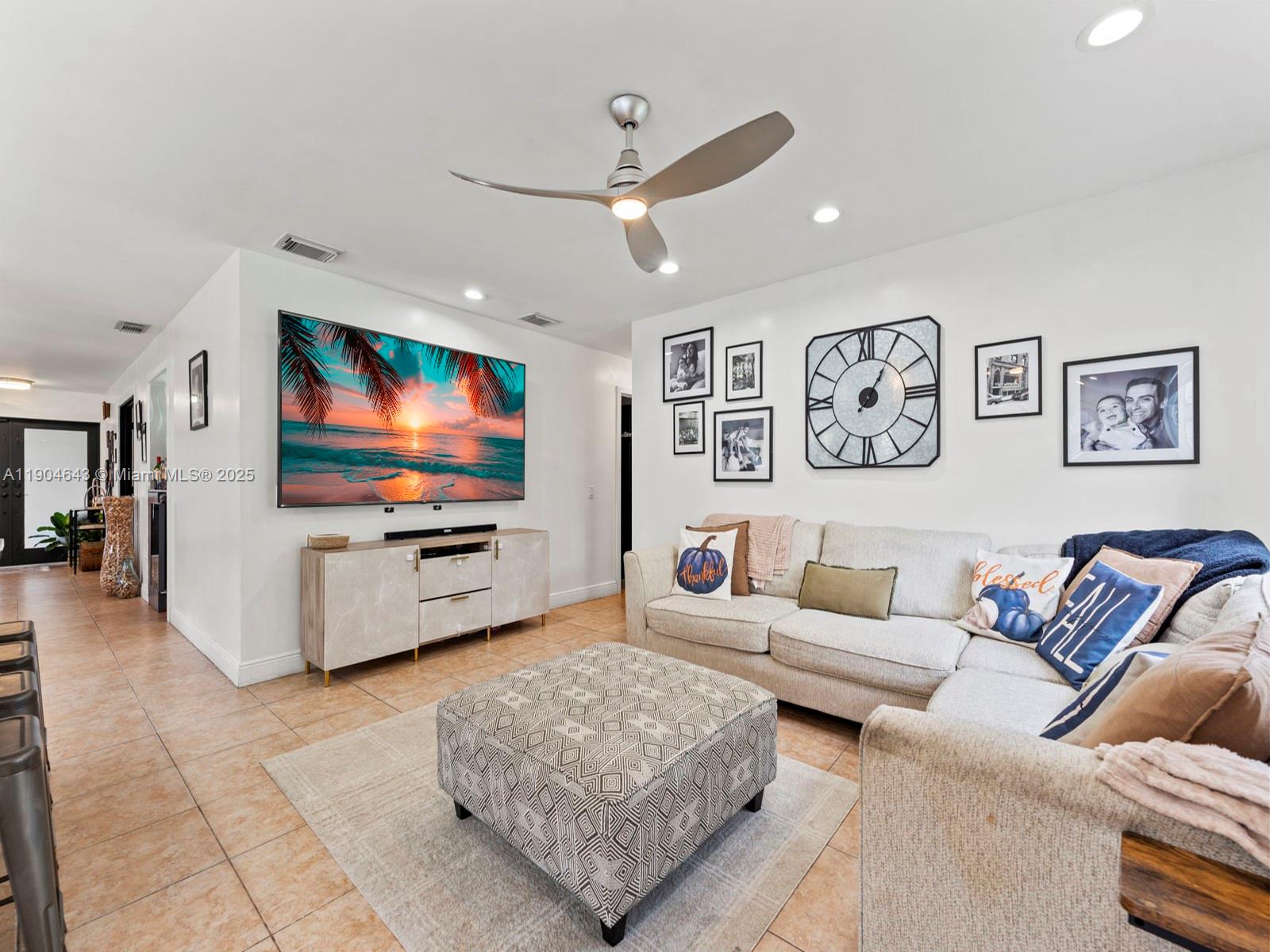 12825 Southwest 107th Terrace Miami, FL 33186 - Photo 22 of 43 a living room with furniture and a flat screen tv