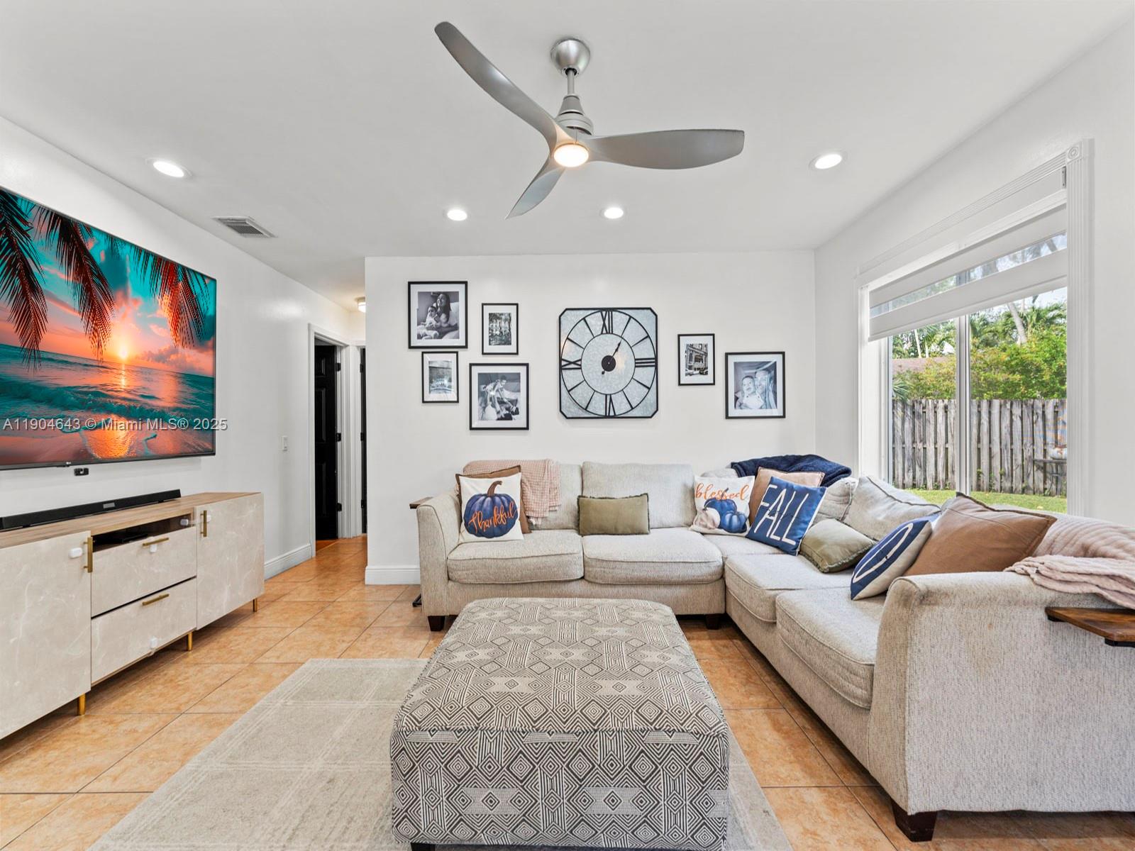 12825 Southwest 107th Terrace Miami, FL 33186 - Photo 23 of 43 a living room with furniture flat screen tv and a large window