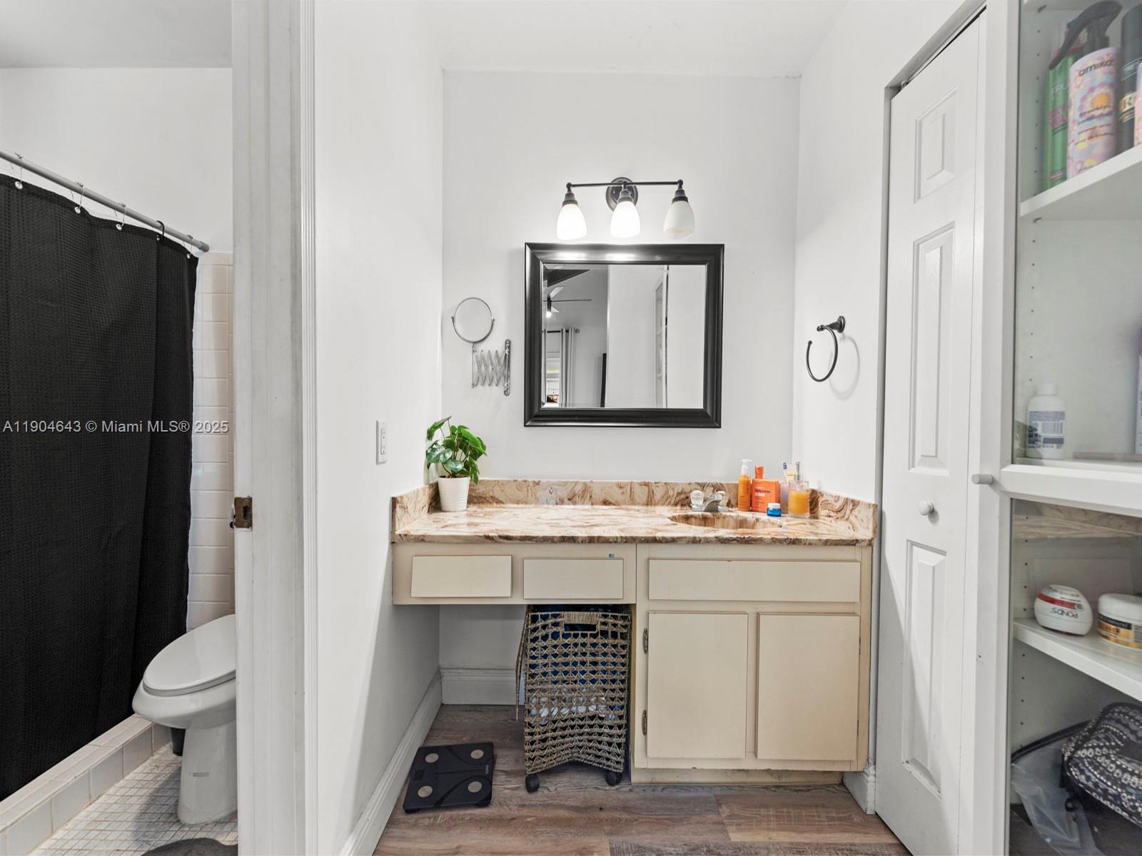 12825 Southwest 107th Terrace Miami, FL 33186 - Photo 27 of 43 a bathroom with a sink a toilet and a mirror