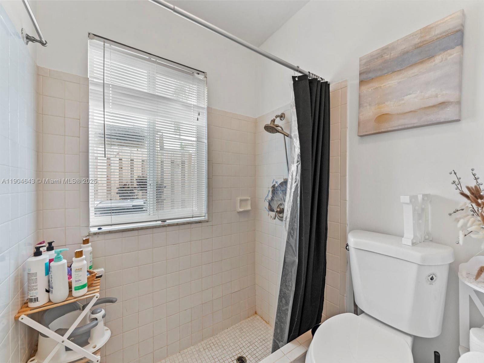 12825 Southwest 107th Terrace Miami, FL 33186 - Photo 28 of 43 a bathroom with a toilet and a shower