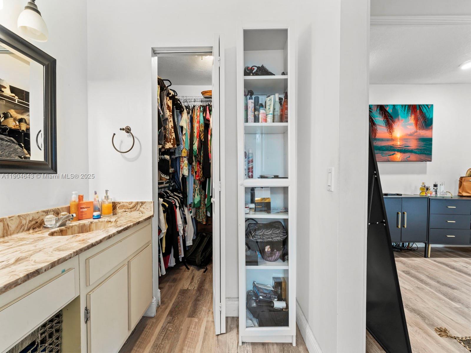 12825 Southwest 107th Terrace Miami, FL 33186 - Photo 29 of 43 a hallway with cabinets and wooden floor