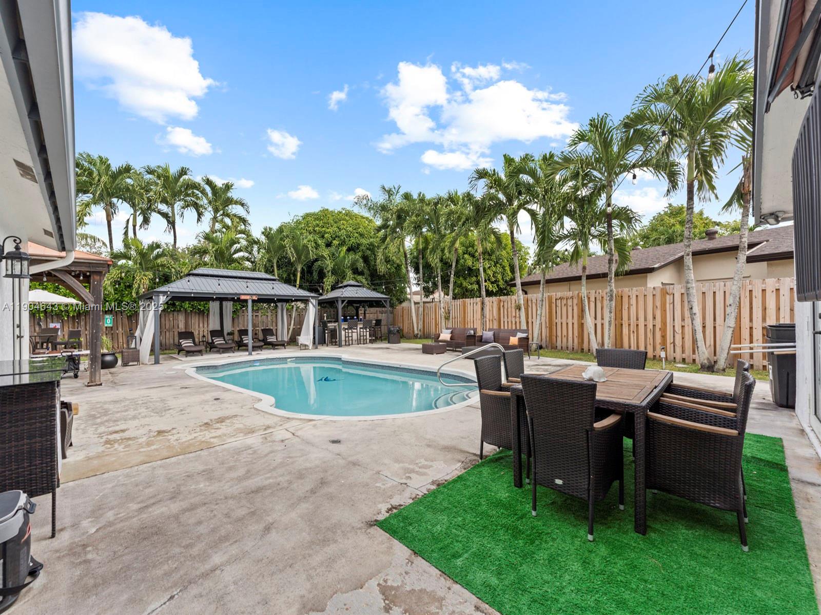 12825 Southwest 107th Terrace Miami, FL 33186 - Photo 34 of 43 a view of a swimming pool with a patio