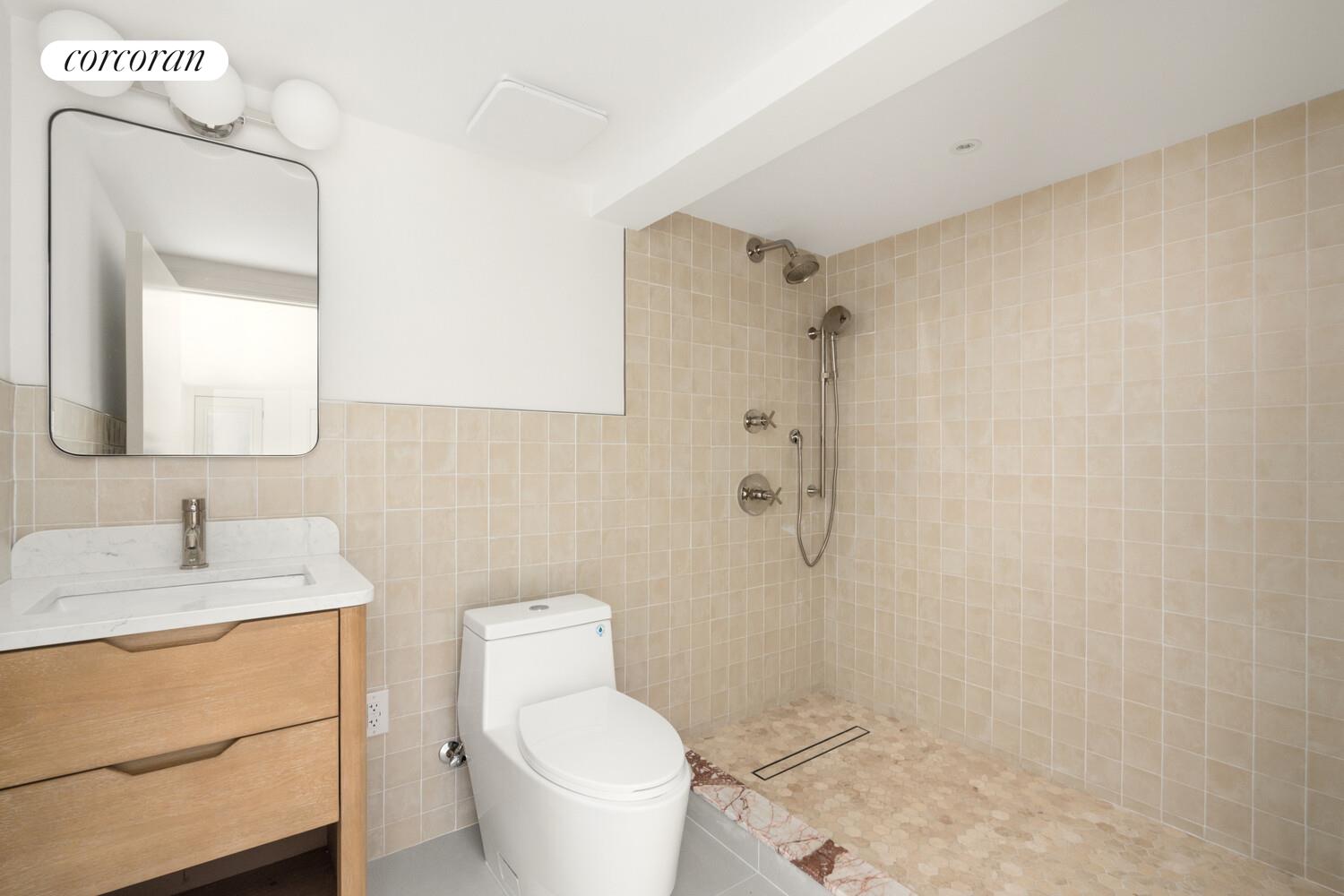 700 Monroe Street Brooklyn, NY 11221 - Photo 17 of 18 a bathroom with a granite countertop sink toilet and shower