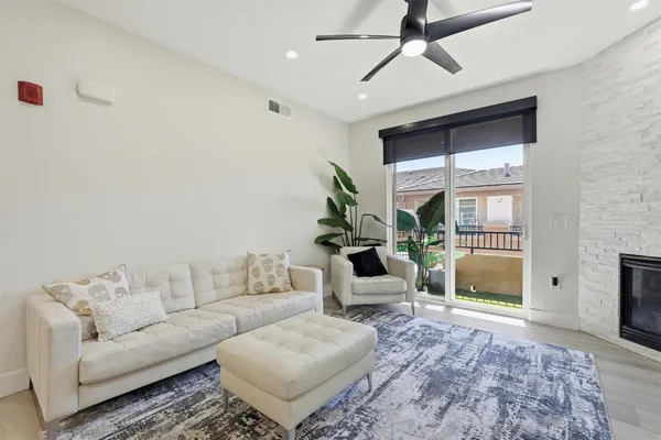 a view of a livingroom with furniture and a kitchen