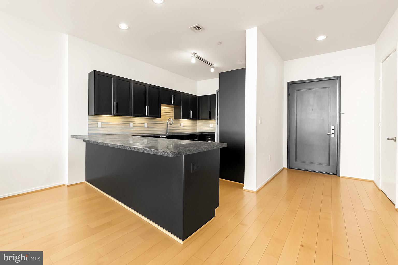 1200 Steuart Street, Unit 912 Baltimore, MD 21230 - Photo 5 of 45 Sleek kitchen w/ island seating