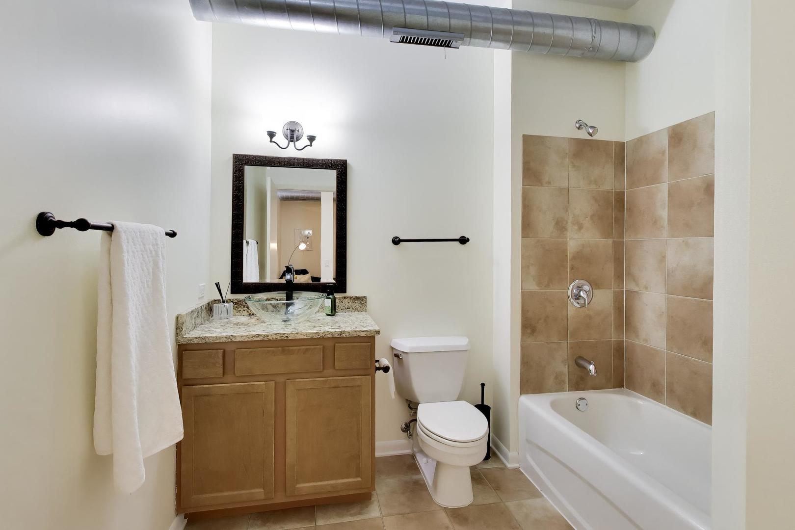 1200 West Monroe Street, Unit 502 Chicago, IL 60607 - Photo 20 of 34 a bathroom with a granite countertop sink toilet and shower