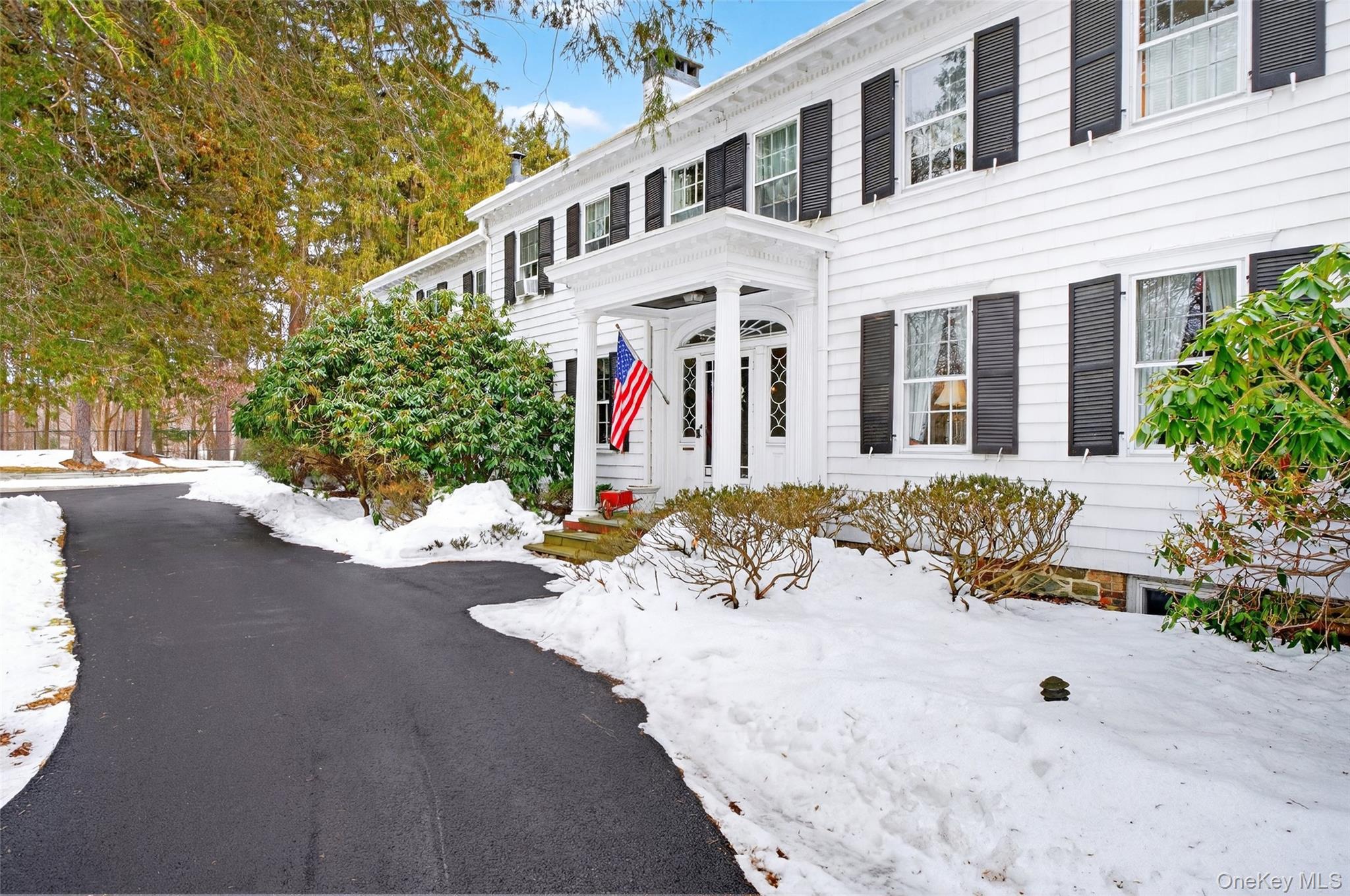 79 Old Balmville Road Newburgh, NY 12550 - Photo 2 of 45 a view of a white house with large trees in front of it