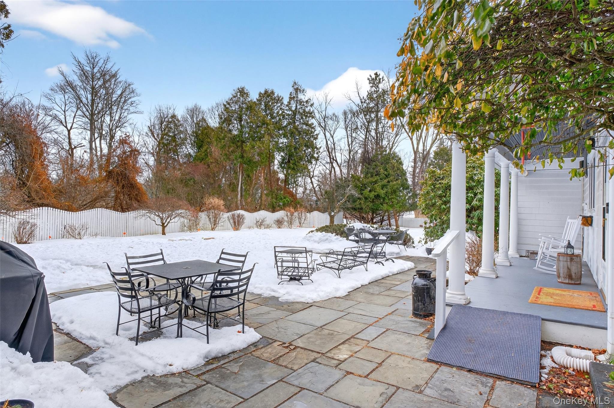 79 Old Balmville Road Newburgh, NY 12550 - Photo 38 of 45 a view of a patio with a dining table and chairs with a fire pit and a large tree