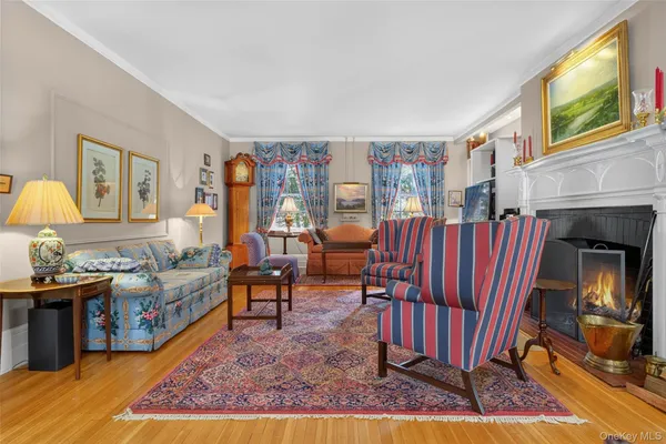 a living room with furniture fireplace and a large window