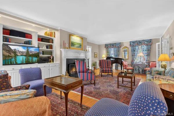 a living room with furniture fireplace and flat screen tv