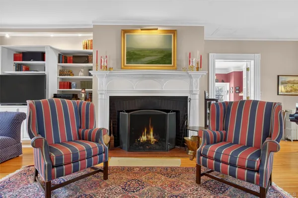 a living room with furniture lamp and book shelf