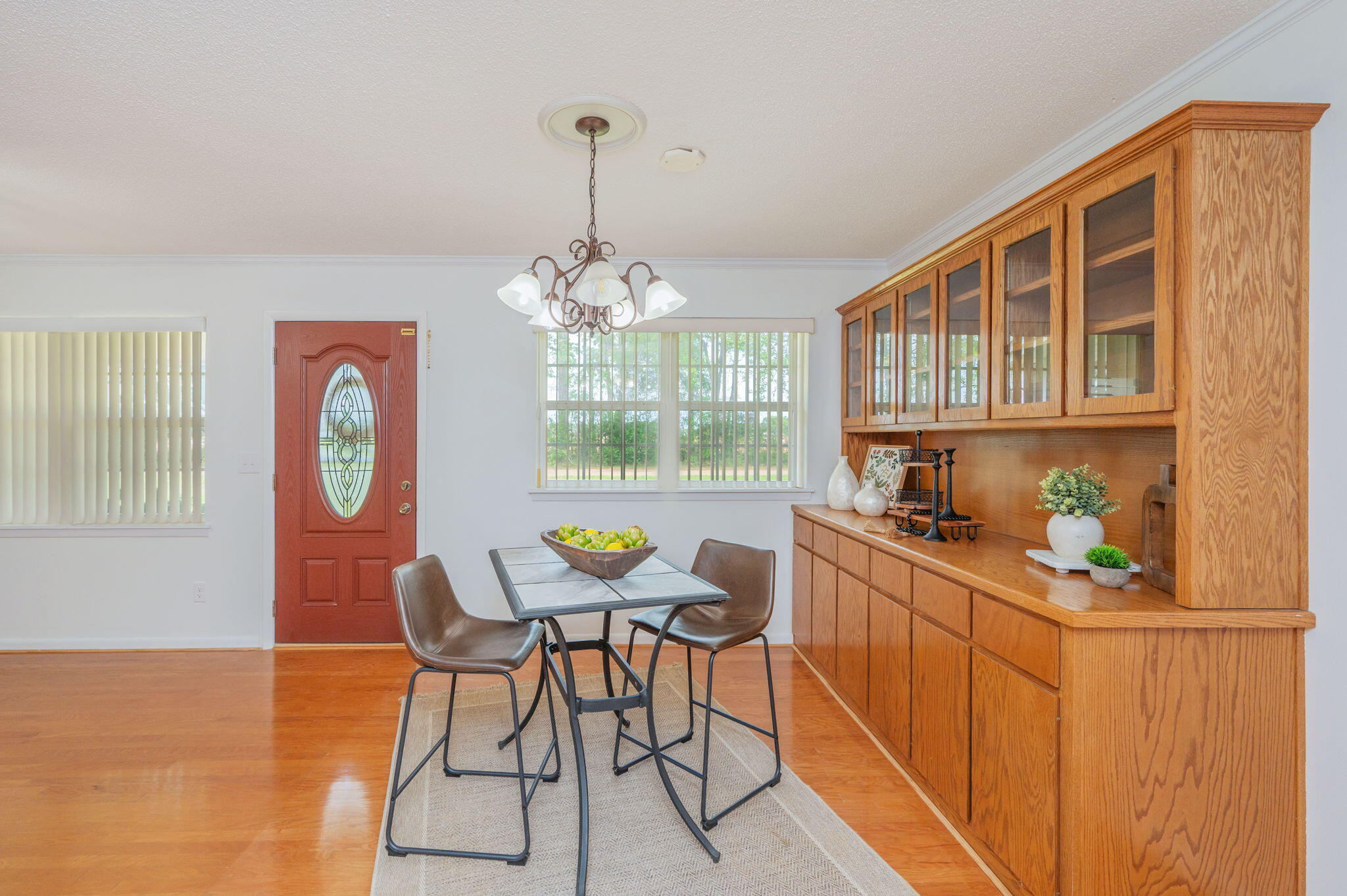 501 Jones Road Crestview, FL 32536 - Photo 5 of 32 a view of a dining room with furniture a chandelier and wooden floor