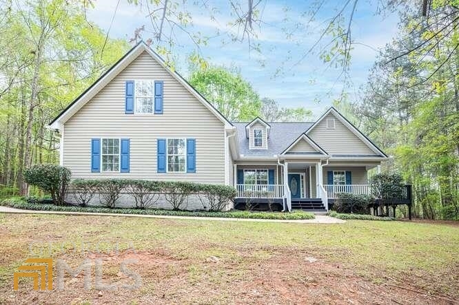 135 Whippoorwill Ridge Road Jackson, GA 30233 - Photo 1 of 1 a front view of a house with a yard and lake view