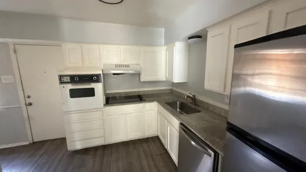 a kitchen with a refrigerator and a sink