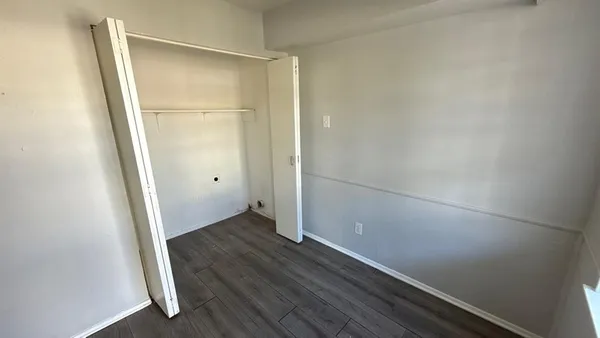 an empty room with wooden floor