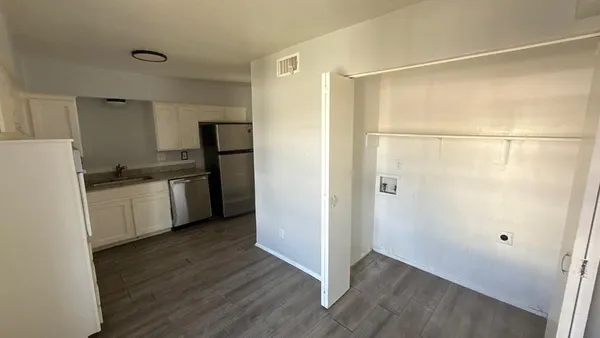 a kitchen with granite countertop a refrigerator and a sink