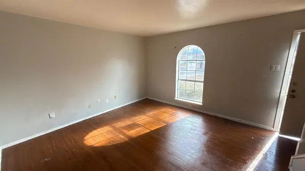 a view of wooden floor and windows in a room