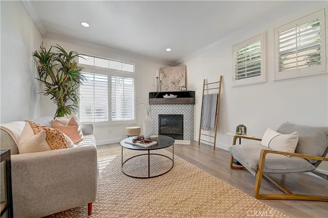 a living room with furniture a fireplace and a table