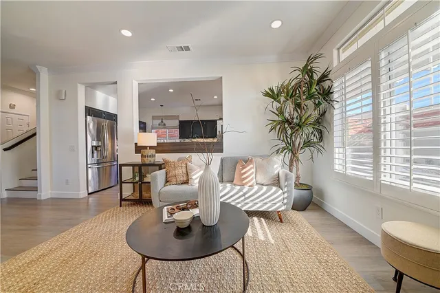 a view of a dining room with furniture and a chandelier