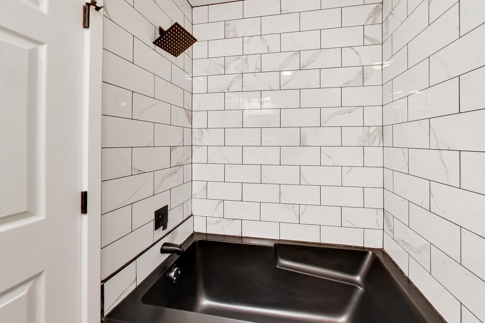 810 Malta Lane Silver Spring, MD 20901 - Photo 22 of 35 Modern shower with a black tub & sleek tile.