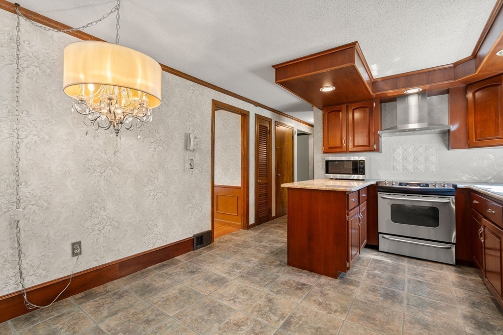 2035 Parker Street Springfield, MA 01128 - Photo 15 of 42 a kitchen with stainless steel appliances granite countertop a stove and a refrigerator