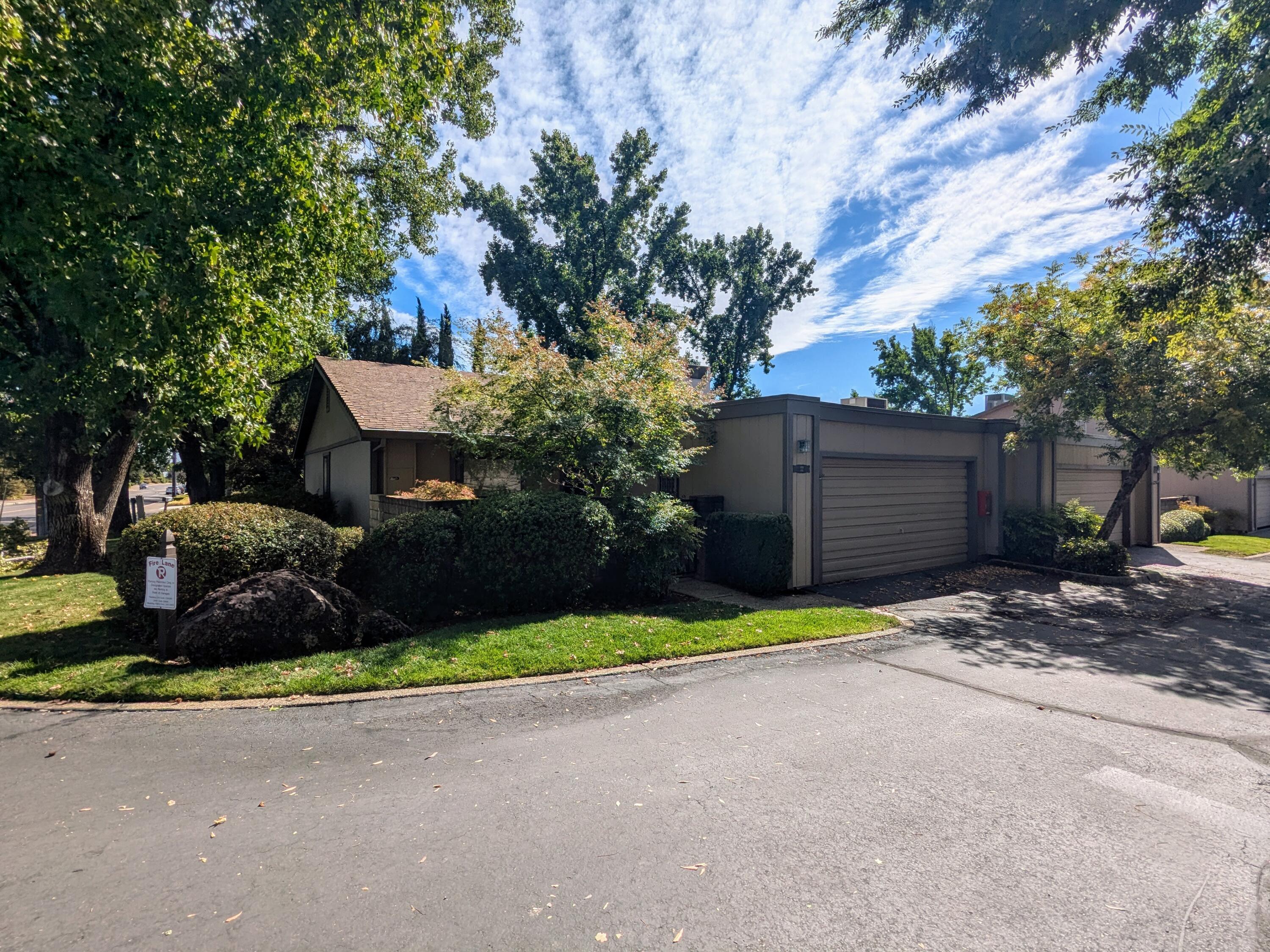 a view of a house with a yard and garage