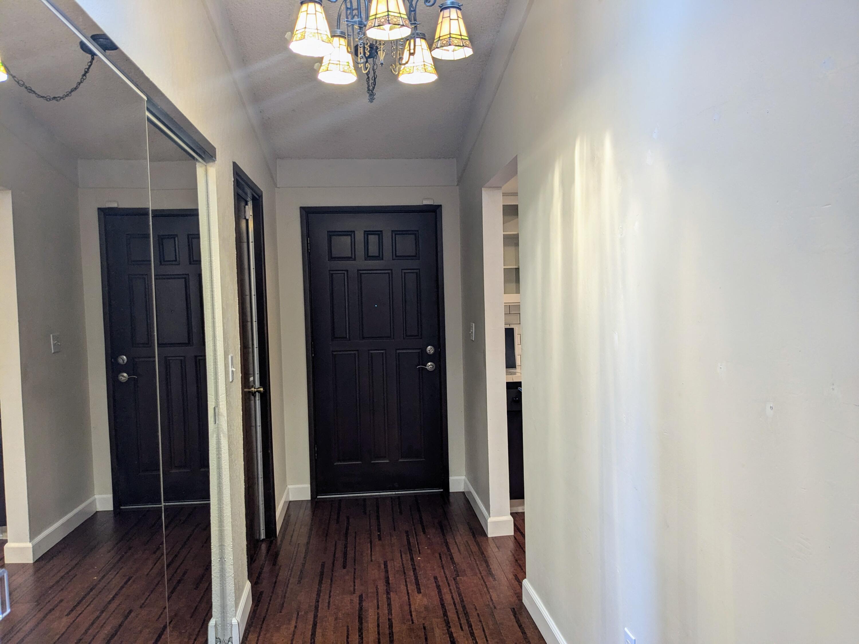 1974 Bechelli Lane Redding, CA 96002 - Photo 11 of 49 a view of a hallway with wooden floor and a chandelier