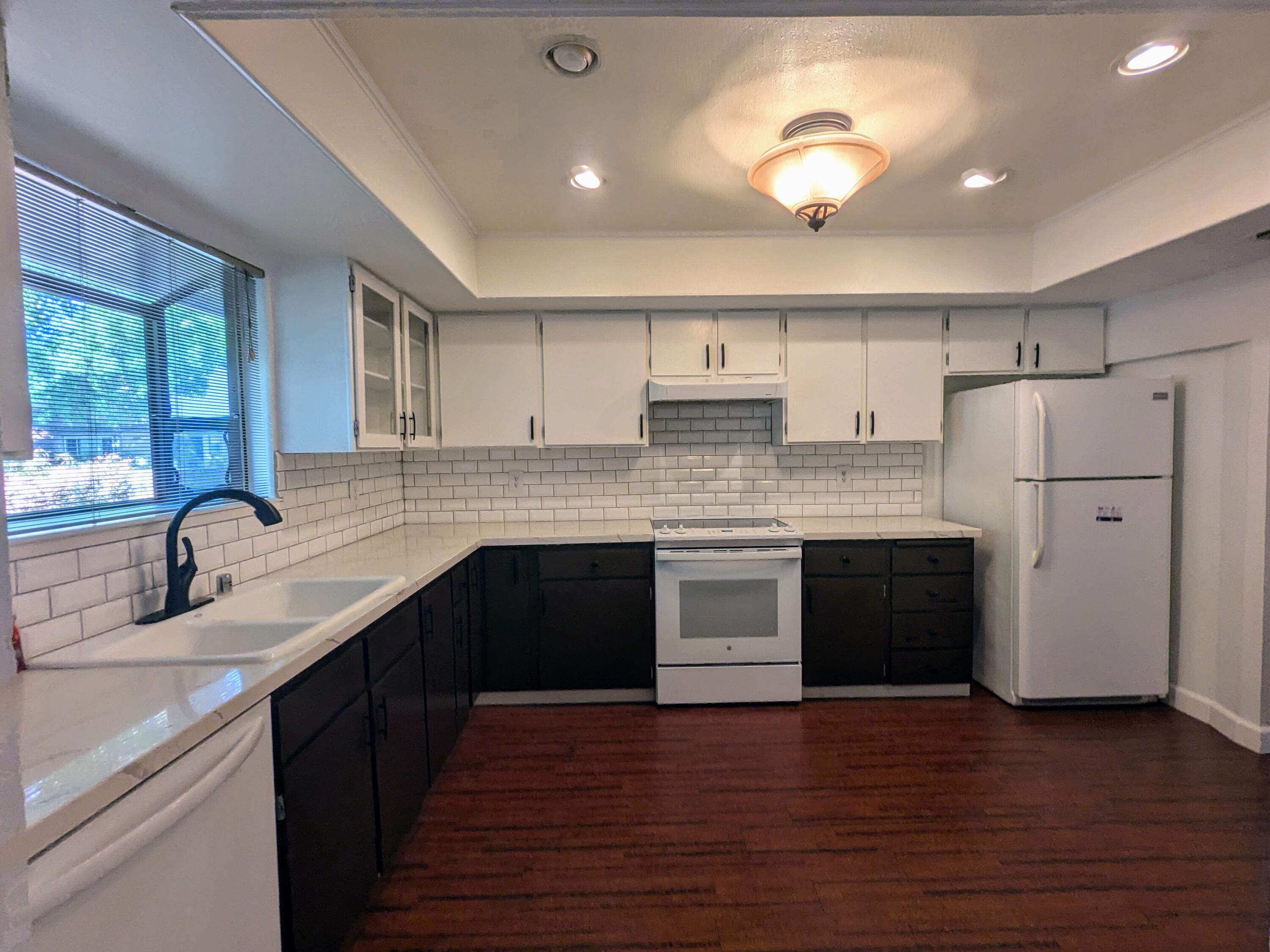 1974 Bechelli Lane Redding, CA 96002 - Photo 13 of 49 a kitchen with stainless steel appliances granite countertop a sink cabinets and wooden floor
